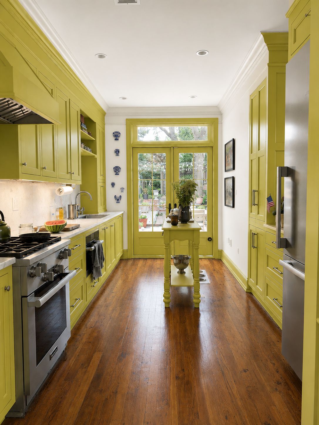 Galley kitchen painted chartreuse, French doors to the garden