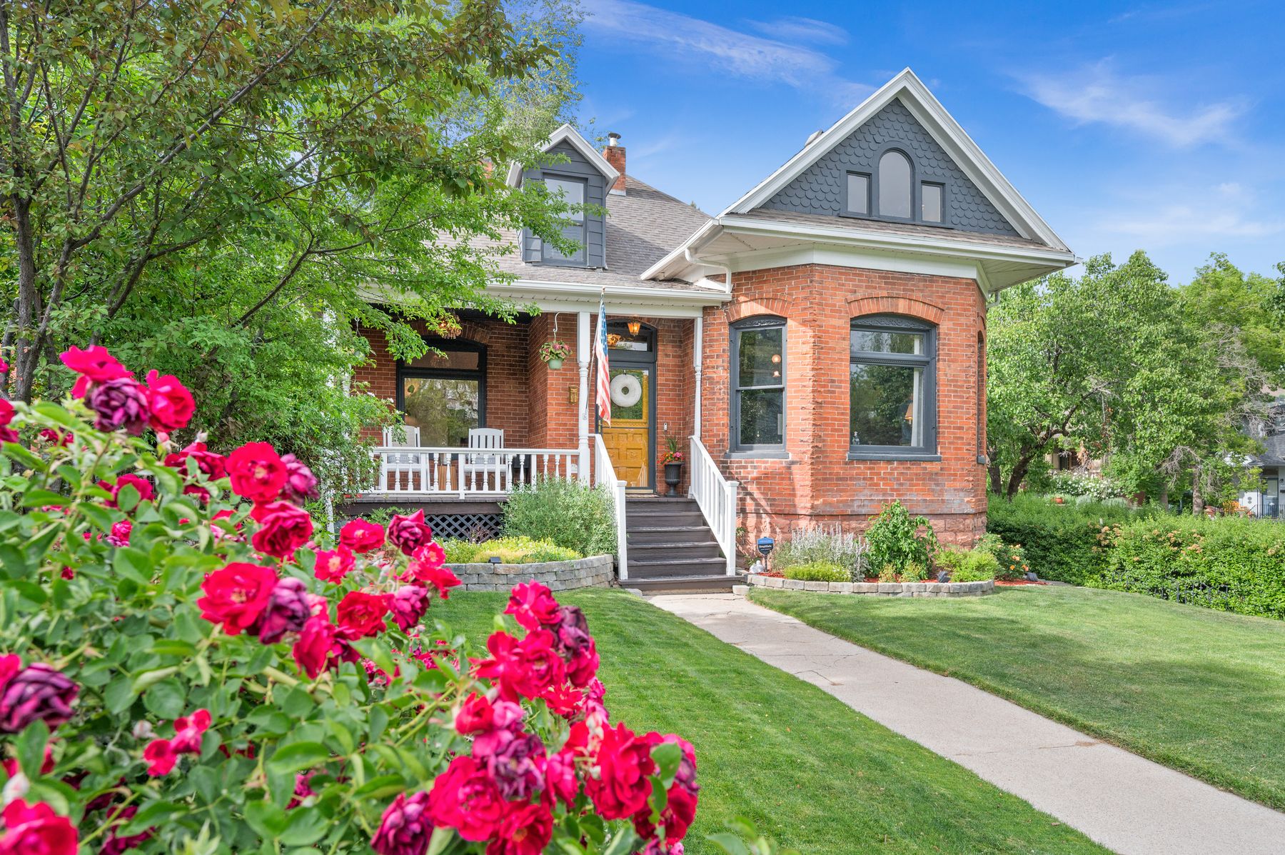 The Schettler House — 1890s brick Victorian behind blooming roses, The Avenues, Salt Lake City